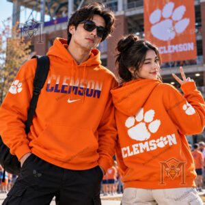 Clemson Tigers Wordmark and Paw Orange Hoodie - model wearing orange hoodie at podium