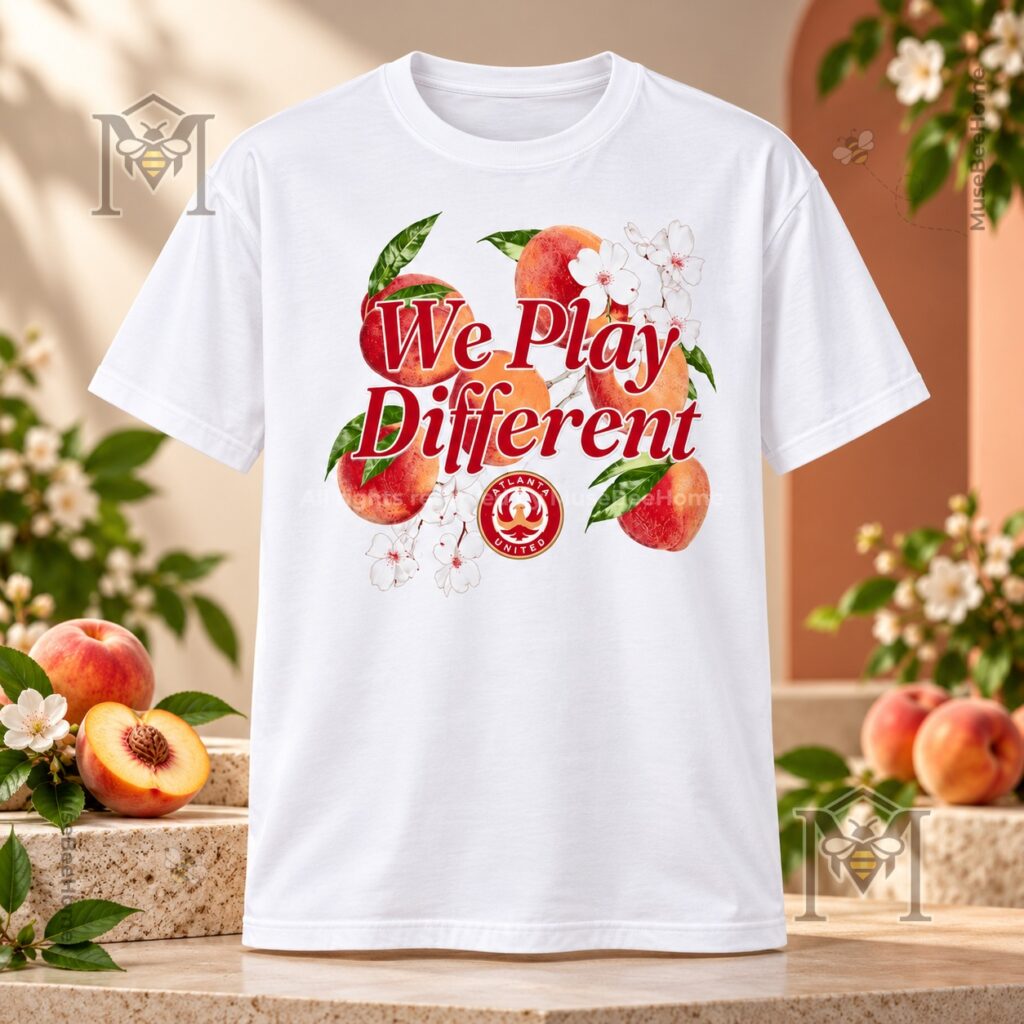 Atlanta United FC We Play Different Georgia Peach T-Shirt – Front view with peach floral Atlanta United FC We Play Different Georgia Peach T-Shirt - front view with peach floral graphic