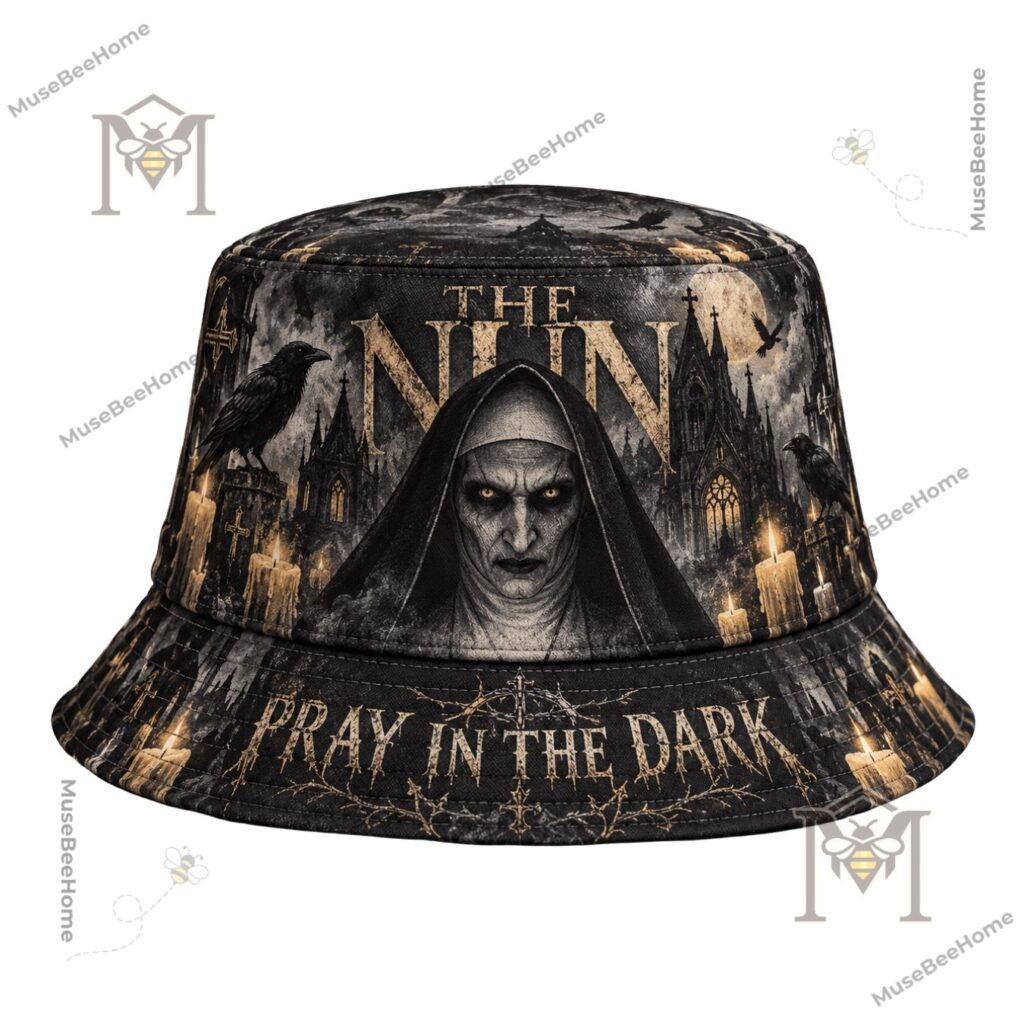 The Nun Pray In The Dark Bucket Hat - close-up of distressed gold lettering and Nun face